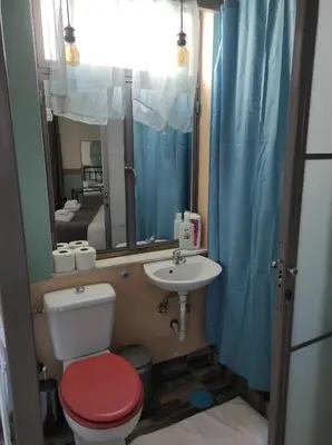 a bathroom with a toilet and a sink and a mirror at Υπέροχη θέα in Athens