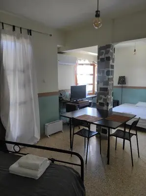 a bedroom with a bed and a table and a desk at Υπέροχη θέα in Athens