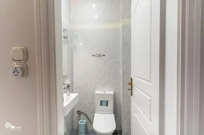 a bathroom with a white toilet and a sink at Hliana - Premium Sky & Sunset View House in Glyfada in Athens