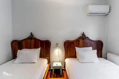 two beds sitting next to each other in a room at Hliana - Premium Sky & Sunset View House in Glyfada in Athens