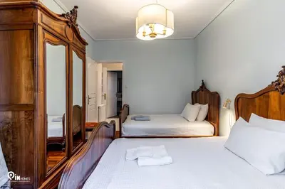 a bedroom with two beds and a dresser and a mirror at Hliana - Premium Sky & Sunset View House in Glyfada in Athens