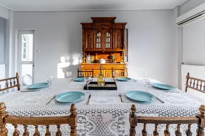 a dining room with a table with blue plates at Hliana - Premium Sky & Sunset View House in Glyfada in Athens