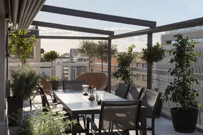 a patio with a table and chairs on a balcony at Athens Golden Light Premium Residence in Athens
