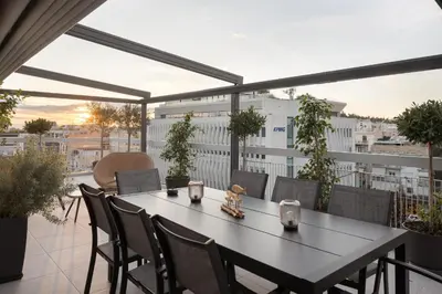 a table and chairs on top of a balcony at Athens Golden Light Premium Residence in Athens
