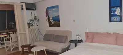 a living room with a couch and a chair at Galatsi Studio Apartment -Attica in Athens