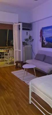 a living room with a couch and a table at Galatsi Studio Apartment -Attica in Athens