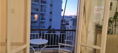 a room with a balcony with a table and a view at Galatsi Studio Apartment -Attica in Athens