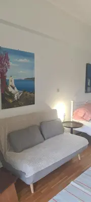 a bed in a room with a painting on the wall at Galatsi Studio Apartment -Attica in Athens