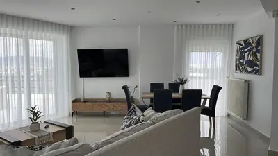 a living room with a couch and a table at Athens Panoramic Penthouse in Athens