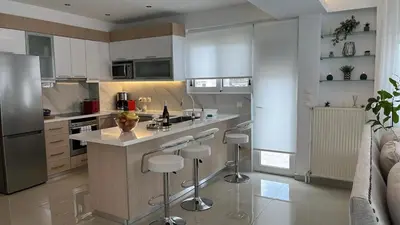 a kitchen with a island with bar stools at Athens Panoramic Penthouse in Athens