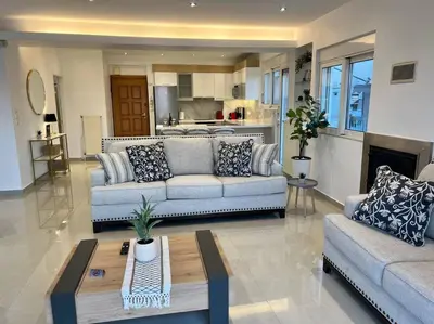 a living room with two couches and a table at Athens Panoramic Penthouse in Athens