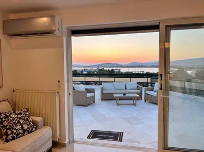 a living room with a view of a balcony at Athens Panoramic Penthouse in Athens