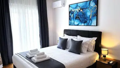 a bedroom with a large bed with towels on it at Athens Panoramic Penthouse in Athens
