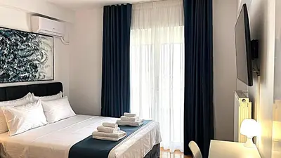 a bedroom with a bed with towels on it at Athens Panoramic Penthouse in Athens