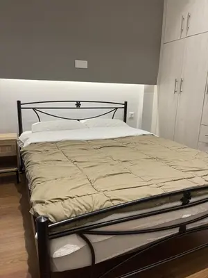a bedroom with a large bed with a black frame at Bonas House in Athens