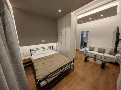 a bedroom with a bed and a couch at Bonas House in Athens