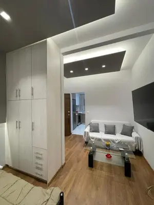 a bedroom with a bed and a tv in it at Bonas House in Athens