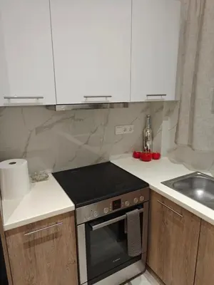 a kitchen with a stove top oven next to a sink at Bonas House in Athens