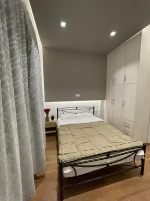 a bedroom with a bed and a large window at Bonas House in Athens