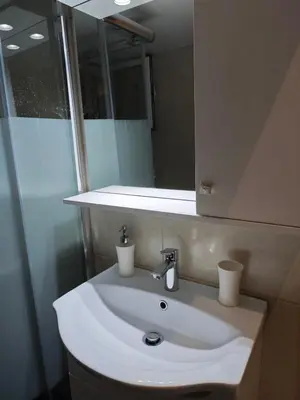 a bathroom with a white sink and a mirror at Bonas House in Athens