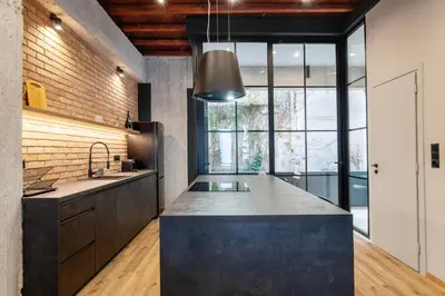 a kitchen with a large island in the middle at Isoyio in Piraeus