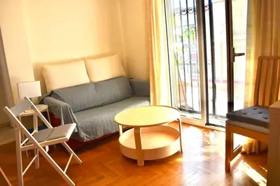 a living room with a couch and a table at Quiet penthouse at 5th floor in Athens