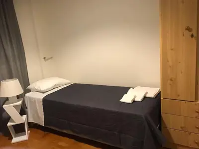 a bedroom with a black bed with two white pillows at Quiet penthouse at 5th floor in Athens