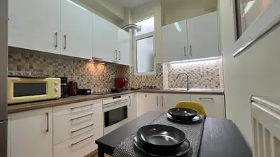 a kitchen with a table with two black bowls on it at Elegant apartment in Thissio in Athens
