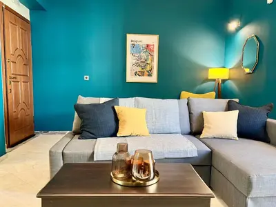 a living room with a couch and a table at Elegant apartment in Thissio in Athens