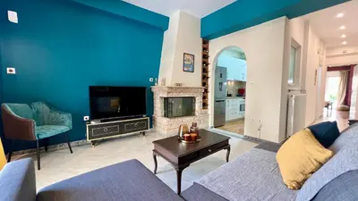 a blue living room with a couch and a fireplace at Elegant apartment in Thissio in Athens