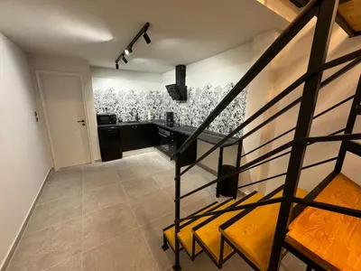 a kitchen with a staircase leading to a room with a counter at Loft Athens 2 - 55m2 in Athens