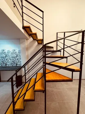 a metal spiral staircase in a house at Loft Athens 2 - 55m2 in Athens