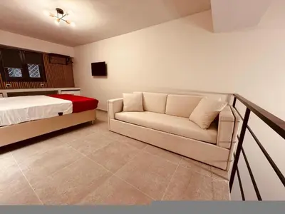 a bedroom with a bed and a couch in it at Loft Athens 2 - 55m2 in Athens