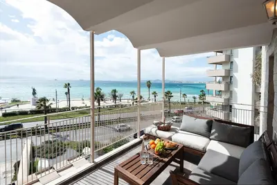 a balcony with a couch and a view of the ocean at Zeus3 Beach Front Appartment, 2 BR, Sea View in Athens