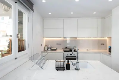a white kitchen with a sink and a counter at Zeus3 Beach Front Appartment, 2 BR, Sea View in Athens