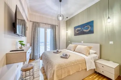 a bedroom with a bed and a sink and a mirror at Manolias Apartment in Athens