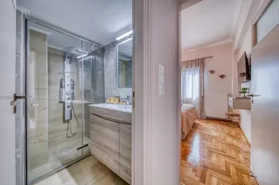 a bathroom with a shower and a sink at Manolias Apartment in Athens