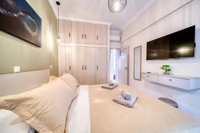 a bedroom with a bed with towels on it at Manolias Apartment in Athens