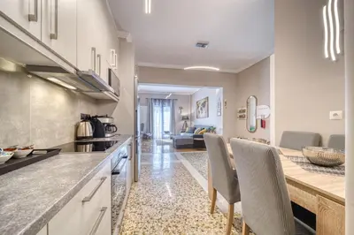 a kitchen with a counter and chairs in a room at Manolias Apartment in Athens