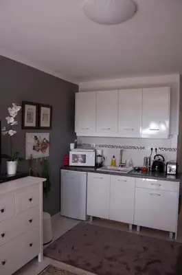 a kitchen with white cabinets and a microwave at Modern Studio - Terrace & Seaview - Close to Beach in Saronida