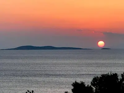 a sunset over the ocean with the sun in the sky at Modern Studio - Terrace & Seaview - Close to Beach in Saronida