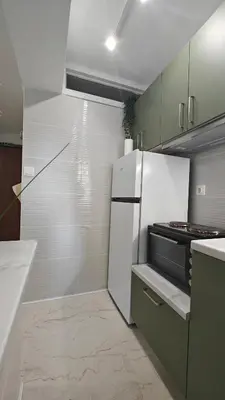 a kitchen with a white refrigerator and a stove at Inspire Apartment Palaio Faliro in Athens