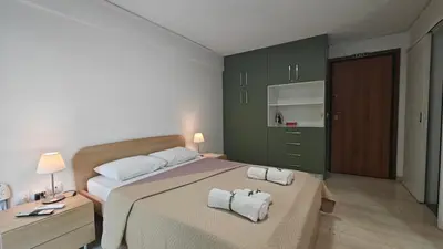 a bedroom with a bed with towels on it at Inspire Apartment Palaio Faliro in Athens
