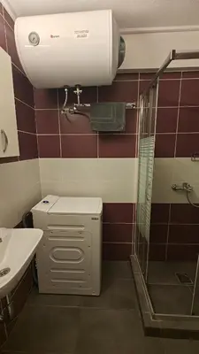 a bathroom with a shower and a toilet and a sink at Inspire Apartment Palaio Faliro in Athens