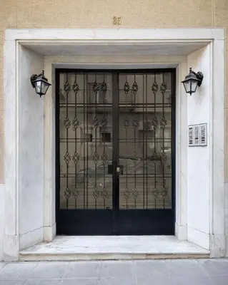 a door to a building with a wrought iron gate at Kolonaki Suite with Panoramic View in Athens