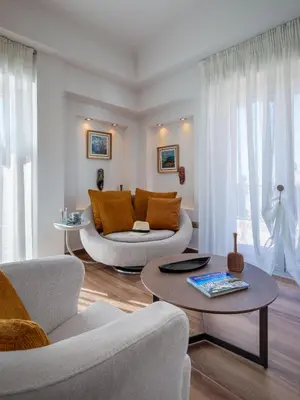 a living room with a couch and a table at Kolonaki Suite with Panoramic View in Athens