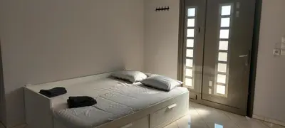 a bedroom with a bed with two towels on it at Gianni & Sophia airport house in Artemida