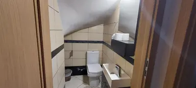 a small bathroom with a toilet and a sink at Gianni & Sophia airport house in Artemida