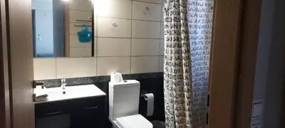 a bathroom with a toilet and a sink and a mirror at Gianni & Sophia airport house in Artemida