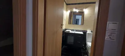 a bathroom with a sink and a mirror at Gianni & Sophia airport house in Artemida